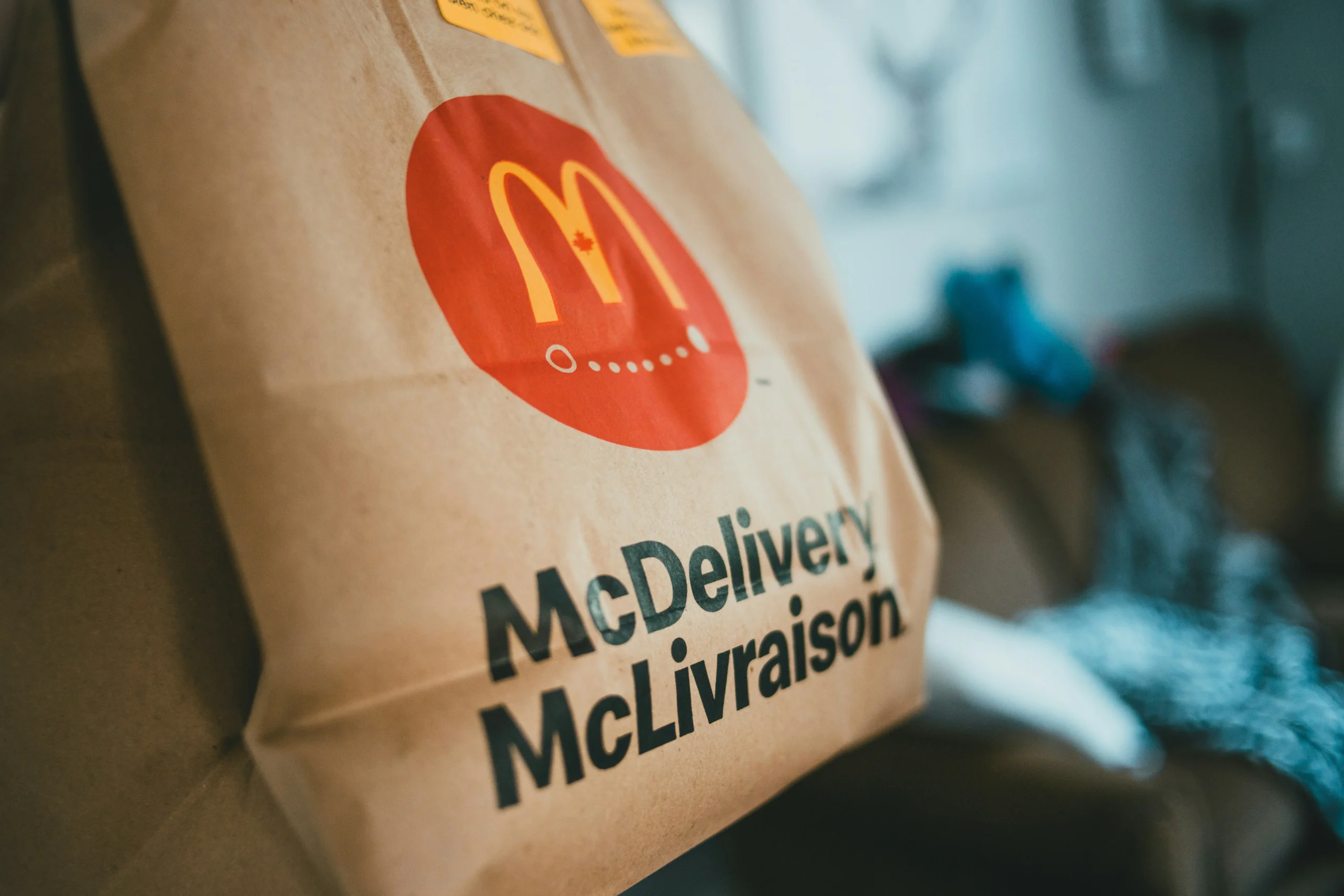 A brown McDonald's takeout bag that shows the brand recognition of inspirational brands.