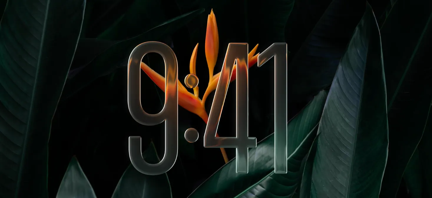 A vibrant workspace featuring a laptop displaying the "9:41" time with a "Liquid Glass" effect, showcasing translucent overlays and soft reflections against a dark floral background.